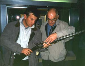 Andrey Legoshin and Ned Rimmer look at a WWII riffle in the museum of RLC