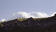 Three hikers with Mt Elbrus on the background