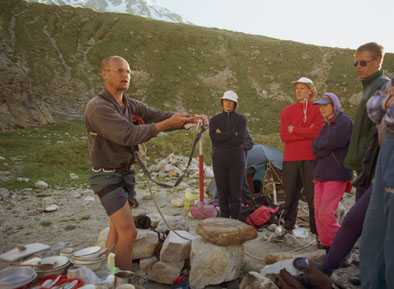 A guide's giving a rope course for beginners.