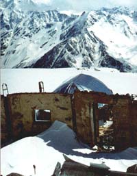 Ruins of the Priyut and the roof of the new shelter behind